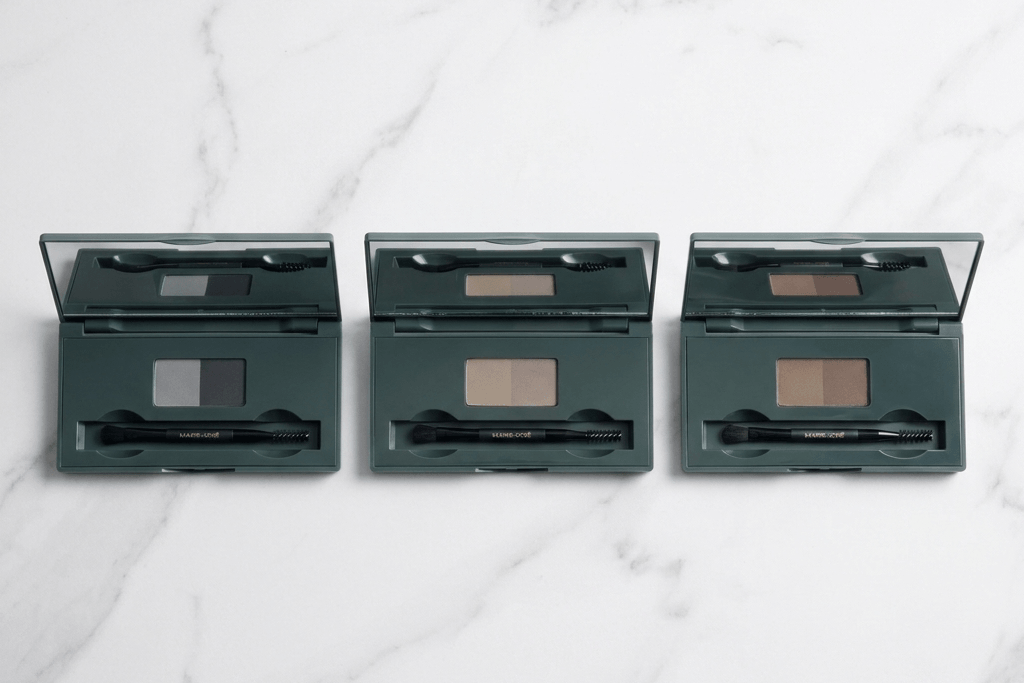 Three open eyeshadow palettes on a marble surface